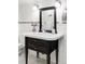 Charming bathroom featuring white tile, a dark wood vanity, and elegant fixtures at 1272 S Milwaukee St, Denver, CO 80210