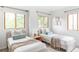 Bright bedroom with two twin beds, wood trim windows, and neutral decor at 1272 S Milwaukee St, Denver, CO 80210
