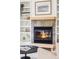 Close up of the living room fireplace with decorative mantel and tile surround at 1272 S Milwaukee St, Denver, CO 80210