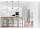 Bright kitchen featuring a breakfast bar with wicker stools and stainless steel appliances at 1272 S Milwaukee St, Denver, CO 80210