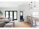 Open-concept living room with modern furniture, hardwood floors, and access to the kitchen and outdoor space at 1272 S Milwaukee St, Denver, CO 80210