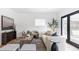 Cozy living room with modern furniture, neutral tones, and natural light from glass block window and doors at 1272 S Milwaukee St, Denver, CO 80210