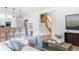 Open-concept living room and kitchen area with modern furnishings and hardwood floors at 1272 S Milwaukee St, Denver, CO 80210