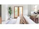 Comfortable main bedroom with a neutral color scheme, hardwood floors, and access to private balcony at 1272 S Milwaukee St, Denver, CO 80210