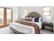 Comfortable main bedroom featuring soft colors, a textured headboard, and access to a private balcony at 1272 S Milwaukee St, Denver, CO 80210
