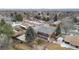 Backyard of red brick home shows a fenced yard with mature trees in a suburban community at 4731 W 66Th Ave, Arvada, CO 80003