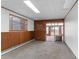 Finished basement area showcasing paneled walls, carpeting, and access to a sunroom with sliding glass doors at 4731 W 66Th Ave, Arvada, CO 80003