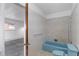 Compact bathroom featuring a blue bathtub and retro tile accents at 4731 W 66Th Ave, Arvada, CO 80003