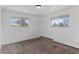 Cozy bedroom with neutral carpet, two windows, and natural light at 4731 W 66Th Ave, Arvada, CO 80003