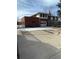 Exterior view of the home featuring a brick facade, garage, and mature trees at 4731 W 66Th Ave, Arvada, CO 80003