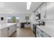 Modern kitchen with white cabinets, stainless steel appliances, and a large island, great for entertaining at 4731 W 66Th Ave, Arvada, CO 80003