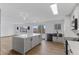 Open-concept kitchen with a large island, stylish lighting, and stainless steel appliances, ready for Gathering gatherings at 4731 W 66Th Ave, Arvada, CO 80003