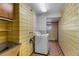 Laundry room with yellow brick, appliances and natural light from window at 4731 W 66Th Ave, Arvada, CO 80003