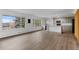 Bright, open-concept living room and kitchen area with wood floors and plenty of natural light at 4731 W 66Th Ave, Arvada, CO 80003