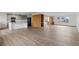 Open-concept living room and kitchen area with wood floors and an eat-in kitchen island at 4731 W 66Th Ave, Arvada, CO 80003