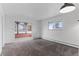 Open living room with neutral carpet and doorway into a sunroom with lots of natural light at 4731 W 66Th Ave, Arvada, CO 80003