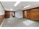 Spacious living room featuring paneled walls, carpeted flooring, and bright overhead lighting at 4731 W 66Th Ave, Arvada, CO 80003