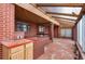 Sunroom featuring brick accents, wood trim, and access to backyard at 4731 W 66Th Ave, Arvada, CO 80003