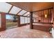 Sunroom with brick flooring, transparent skylights, and a wooden deck at 4731 W 66Th Ave, Arvada, CO 80003