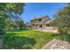 An expansive and manicured backyard offering a perfect blend of lawn and mature trees at 20596 E Shefield Ct, Parker, CO 80138