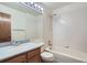 Well-maintained bathroom with a vanity, mirror, tile walls, and a combined tub and shower at 20596 E Shefield Ct, Parker, CO 80138
