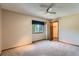 Spacious bedroom features neutral colored walls, a ceiling fan, carpet, and natural light at 20596 E Shefield Ct, Parker, CO 80138