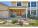 Inviting front porch with seating area, brick facade, beautiful wooden door, and landscaping at 20596 E Shefield Ct, Parker, CO 80138