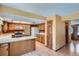 Charming kitchen with wood cabinets, white countertops, and a view into the adjacent living area at 20596 E Shefield Ct, Parker, CO 80138