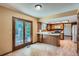 Open kitchen and breakfast nook feature wood floors and sliding door access to the backyard at 20596 E Shefield Ct, Parker, CO 80138