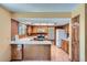 Traditional kitchen with light wood cabinets, white countertops, and a breakfast bar area at 20596 E Shefield Ct, Parker, CO 80138