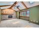 Cozy living room featuring vaulted ceilings with skylights, wood beams and brick fireplace at 20596 E Shefield Ct, Parker, CO 80138
