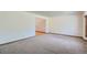 Inviting living room featuring plush carpet and access to connecting rooms through an open doorway at 20596 E Shefield Ct, Parker, CO 80138