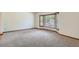 Spacious living room with bay window, plush carpet, and ample natural light at 20596 E Shefield Ct, Parker, CO 80138