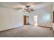 Large main bedroom with neutral carpet, ceiling fan, and an en suite bathroom at 20596 E Shefield Ct, Parker, CO 80138