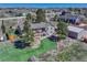 Expansive aerial view of a lovely home with a spacious yard, deck, and outbuilding, perfect for outdoor enjoyment at 7605 Shenandoah Dr, Elizabeth, CO 80107