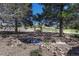 Charming backyard pond and sitting area with wooden swing, perfect for relaxation and enjoying nature at 7605 Shenandoah Dr, Elizabeth, CO 80107