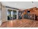 Finished basement with a sliding glass door, stylish bar area, and wood-look flooring, perfect for entertaining at 7605 Shenandoah Dr, Elizabeth, CO 80107