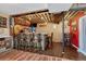 Basement bar with wooden bar and stools, exposed ceiling beams, and recessed lighting at 7605 Shenandoah Dr, Elizabeth, CO 80107