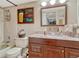 This warm bathroom features a wood vanity, toilet, tub-shower combo, and playful decor at 7605 Shenandoah Dr, Elizabeth, CO 80107