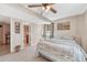 This bedroom offers soft carpet and a ceiling fan above the made bed; an ensuite bathroom is partially visible at 7605 Shenandoah Dr, Elizabeth, CO 80107