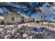 Charming home exterior featuring stone accents, a red door, and tranquil pond at 7605 Shenandoah Dr, Elizabeth, CO 80107