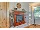 A charming fireplace adds warmth to the room, complemented by a wooden mantel and decorative accents, with natural light at 7605 Shenandoah Dr, Elizabeth, CO 80107