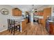 This kitchen offers modern appliances, ample wood cabinetry, a breakfast bar, and access to the laundry room at 7605 Shenandoah Dr, Elizabeth, CO 80107