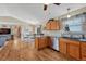 Open kitchen featuring wood cabinets, stainless steel appliances, and adjacent dining area for easy entertaining at 7605 Shenandoah Dr, Elizabeth, CO 80107