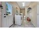 Bright laundry room featuring a modern washer and dryer with tiled floors and convenient access to the backyard at 7605 Shenandoah Dr, Elizabeth, CO 80107