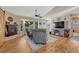 The charming living room features a fireplace, hardwood floors, ceiling fan, and plenty of natural light at 7605 Shenandoah Dr, Elizabeth, CO 80107