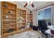Functional office space with built-in bookshelves, providing ample storage and a comfortable workspace at 7605 Shenandoah Dr, Elizabeth, CO 80107