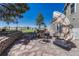 The stone patio has outdoor seating with a fire pit, a green yard, and a pleasant place for gathering at 7605 Shenandoah Dr, Elizabeth, CO 80107