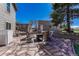 The stone patio has outdoor seating, a fire pit, a shed in the back, and a blue sky above at 7605 Shenandoah Dr, Elizabeth, CO 80107