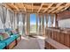 Relaxing sunroom with a hot tub, comfortable seating, and views of the backyard, perfect for unwinding at 7605 Shenandoah Dr, Elizabeth, CO 80107